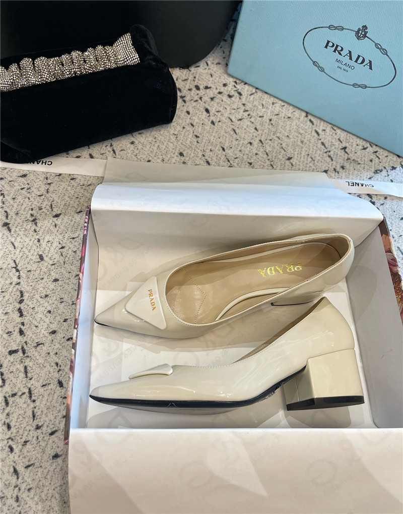 Pra*a triangle logo ivory brushed leather pumps